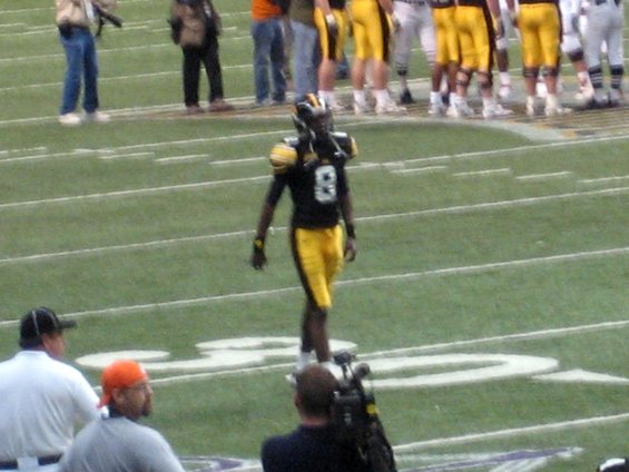 Football player in black and yellow uniform on a field