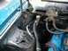 1968 Ford Torino - The engine bay of a 1968 Ford Torino shows blue valve covers and various hoses and components.