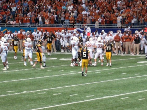 football players on field with crowd in background