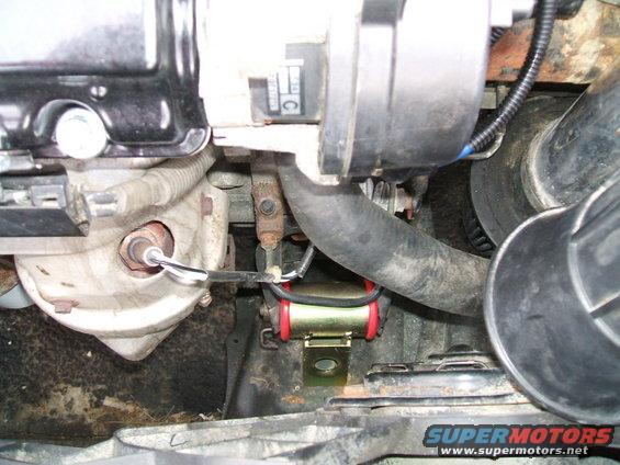 Engine bay part with red and gold bushings