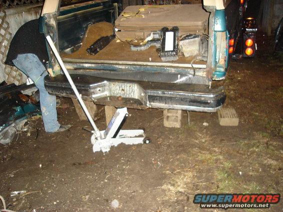 1990 Ford Bronco rear bumper and tailgate area with a jack underneath