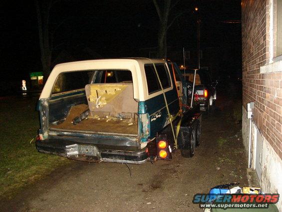 Teal and cream SUV on trailer, rear view. 1990 Ford Bronco