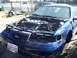 1992 Ford Taurus - Blue 1992 Ford Taurus with hood open, revealing the engine bay. License plate is visible.