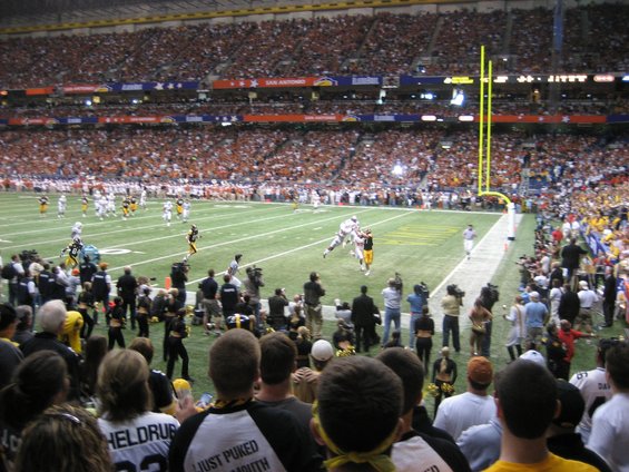 Football game in a stadium with spectators and players on the field