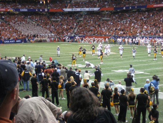 Football game in a stadium with players on the field and spectators in the stands