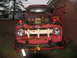 1952 Ford Pickup - This heavily rusted pickup truck features a distinctive white grille and red emergency lights.