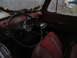 1952 Ford Pickup - The interior of a red pickup truck, likely from the late 1940s, shows a worn steering wheel and seats.