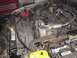 2000 Chevrolet Tahoe - The engine bay of a vehicle, showing various components like the battery, hoses, and air intake system.