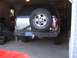 2000 Chevrolet Tahoe - The rear of a silver 2000 Chevrolet Tahoe is visible, equipped with a spare tire and a custom bumper.
