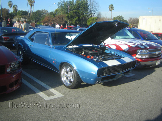 Blue 1967 Chevrolet Camaro RS with hood open, white racing stripes