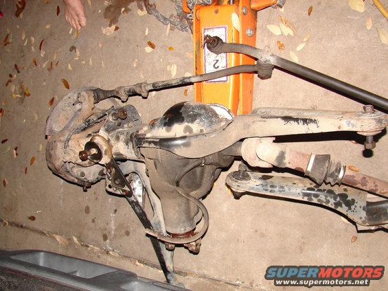 Front axle and suspension parts with a "2" visible on a jack