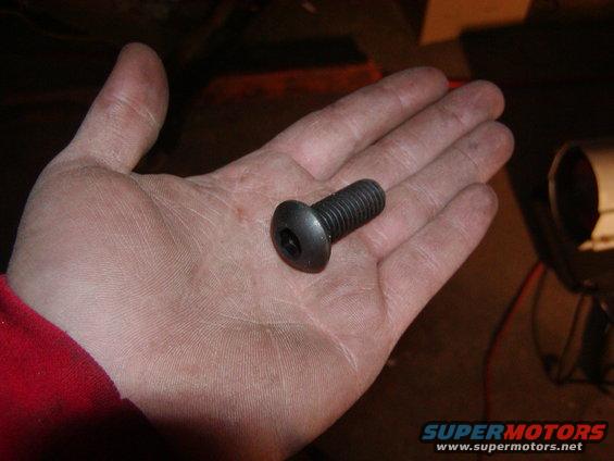 Bolt held in a person's palm, with a red sleeve visible