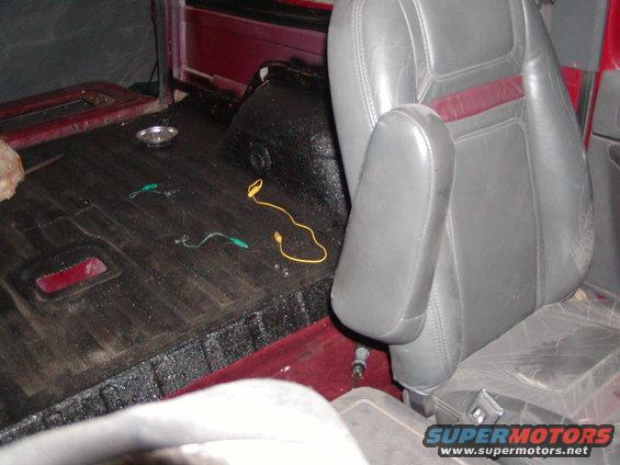 Interior view of vehicle with gray seats and red accents, black floor