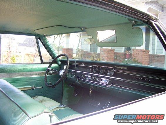 Green interior of a 1965 Pontiac Catalina, showing dashboard and steering wheel