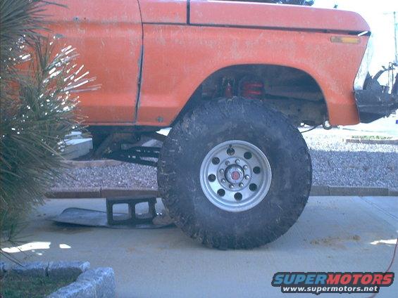 Orange 1978 Ford Bronco side view with large tires and lifted suspension