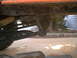 1978 Ford Bronco - Undercarriage view of an orange vehicle, showing suspension and frame details.