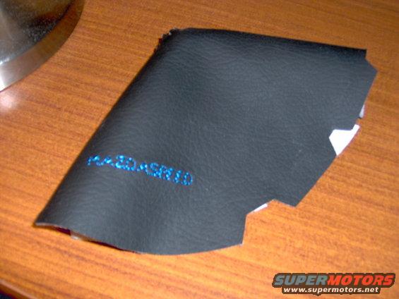 Black leather part with blue text 'F43-30-ASR10'