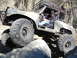 1984 Ford Bronco - Off-road vehicle navigates rocky terrain with a driver at the wheel.