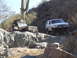 1984 Ford Bronco - Two 4x4s navigate a rocky trail with saguaro cacti in the background.