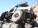 1984 Ford Bronco - Custom buggy navigating a rocky terrain with a clear blue sky overhead.