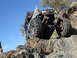1984 Ford Bronco - Custom buggy navigates difficult rocky terrain under a clear blue sky.