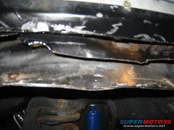 Underside view of vehicle frame with suspension components visible
