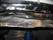 1986 Ford Bronco - Close-up of the underbody structure and suspension parts of a vehicle.