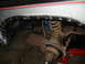1986 Ford Bronco - The wheel well and suspension of a vehicle are shown, with modifications to the fender evident.