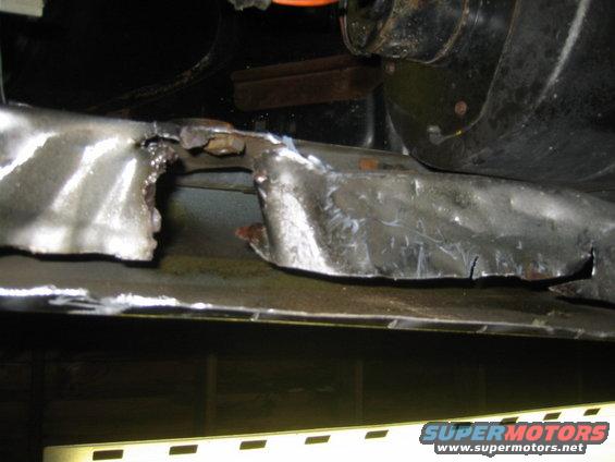 Cut metal frame with jagged edges and welding marks