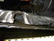 1986 Ford Bronco - Close-up view of a damaged and cut metal frame, likely from a vehicle modification or repair.