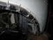 1986 Ford Bronco - The fender of a silver vehicle has been cut into multiple pieces, revealing the internal components and radiator.