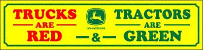 Yellow sign with green border, red text reads "TRUCKS ARE RED", and green text reads "TRACTORS ARE GREEN", with a John Deere logo in the center