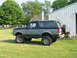1988 Ford Bronco - This 1988 Ford Bronco is shown from a three-quarter front view, parked on a grassy lawn.