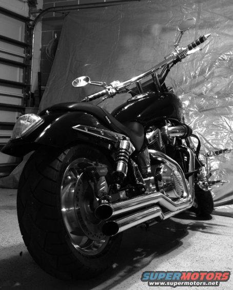 Custom motorcycle with dual exhaust and chrome accents parked indoors