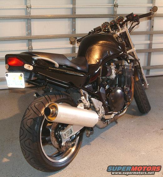 black motorcycle parked in garage, rear view