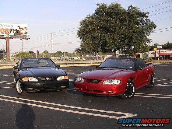 Black and red Ford Mustang convertibles parked side-by-side