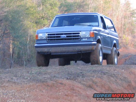 Blue 1989 Ford Bronco 4x4 on dirt road
