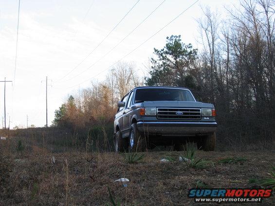 1989 Ford Bronco parked on grassy incline
