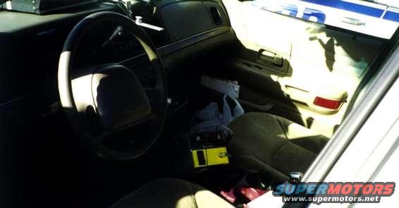 12.jpg Interior snap from the Orange County Vic. This Vic has had its rear AC vents and center armrest removed to make space for police equipment. 
