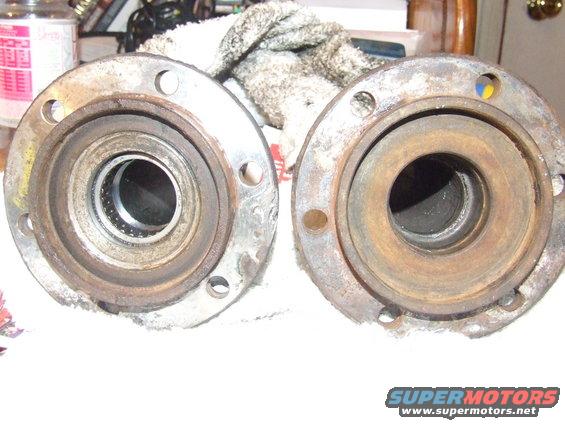 Two used wheel hubs, one with visible bearings, the other rusted