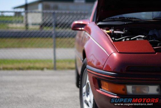 Red 1991 Ford Probe coupe with hood open, seen from the front right