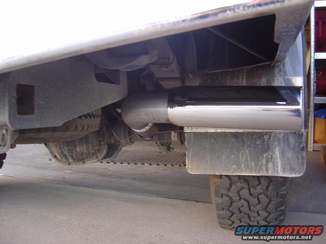 Chrome exhaust tip and rear axle assembly of a vehicle, viewed from below