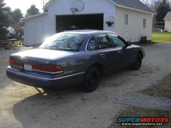 Dark blue 1996 Ford Crown Victoria sedan, rear 3/4 view