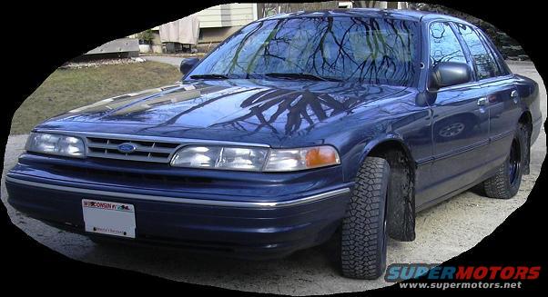 Blue sedan with a Ford grille and Wisconsin plates. Tires look like they are for off-road use