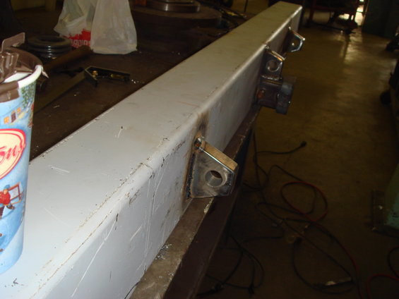 Gray metal bumper section with welded brackets and holes
