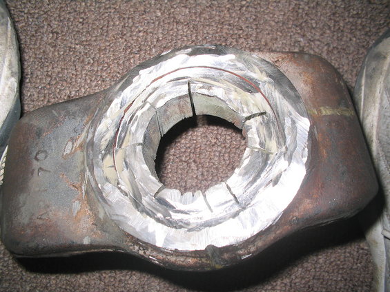 Metal part with machined circular opening and visible '70' marking