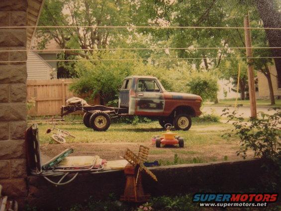 1977 Ford F-150 chassis with cab, side view, primer and red paint