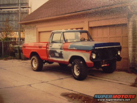 Red and blue pickup truck, primer on doors, parked in driveway