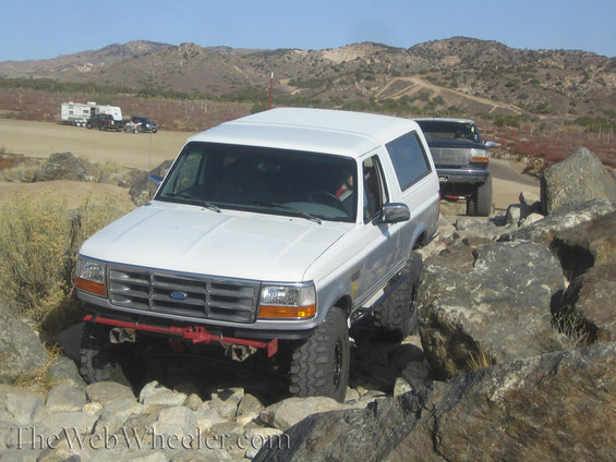 White Ford Bronco navigating rocks, 1992