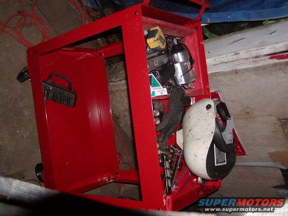 Red toolbox with tools and welding helmet inside